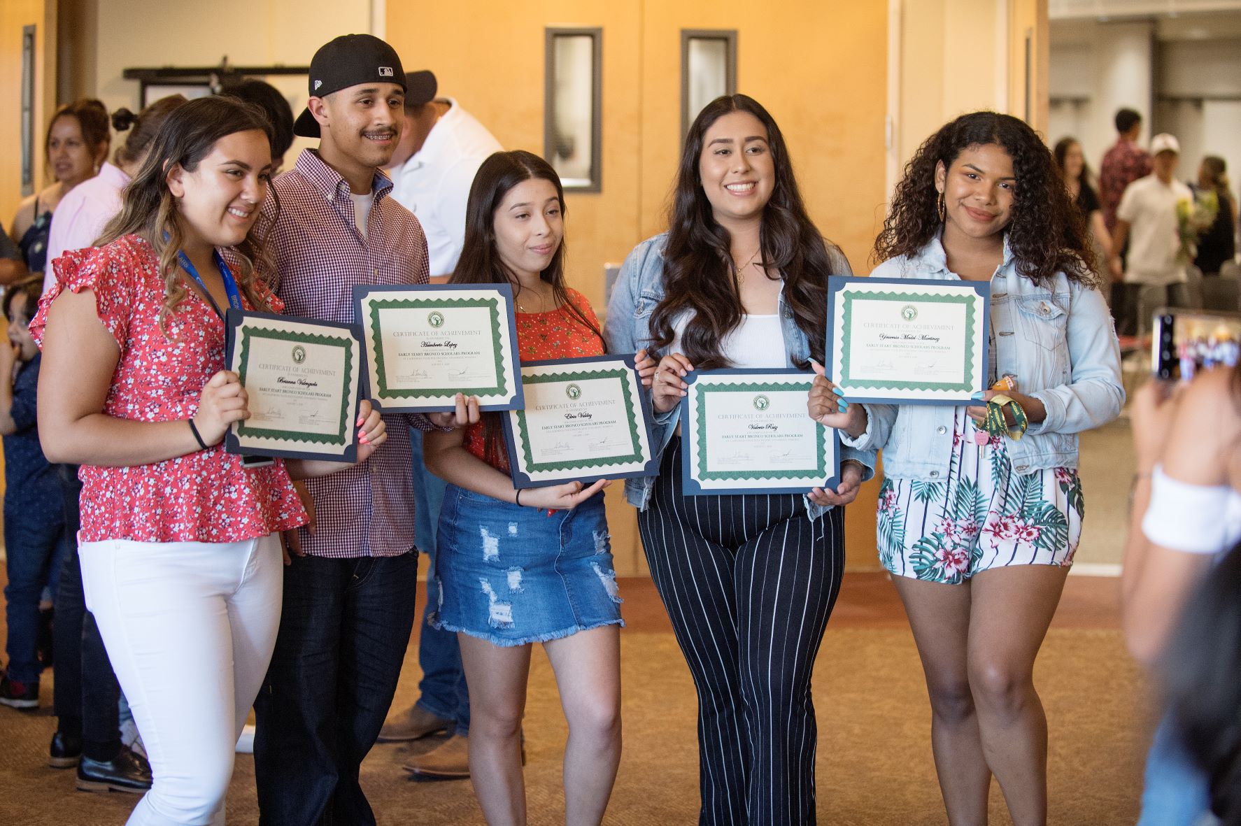 Group of students at Bronco Scholars ceremony holding up certificates