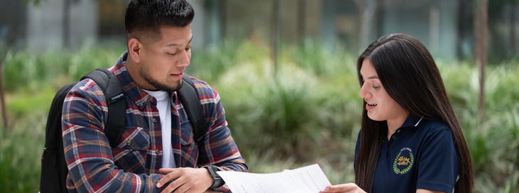 An advisor works with a student on academic planning
