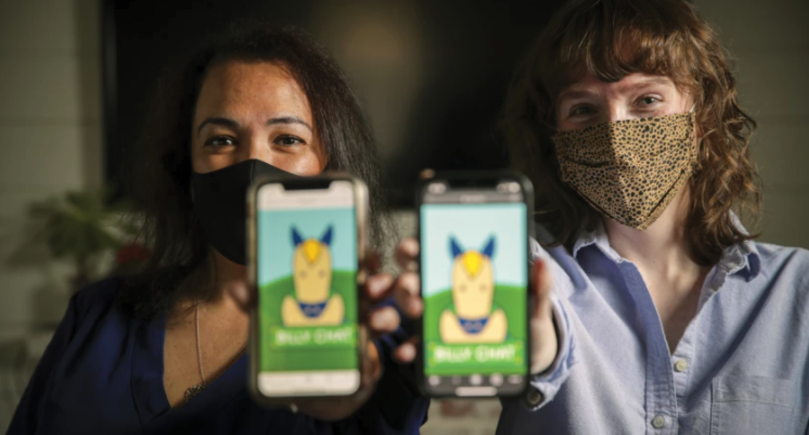 Cecilia Santiago-Gonzalez and Zoe Lance hold phones with Billy Chat logos