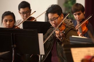 A group of students playing in the orchestra