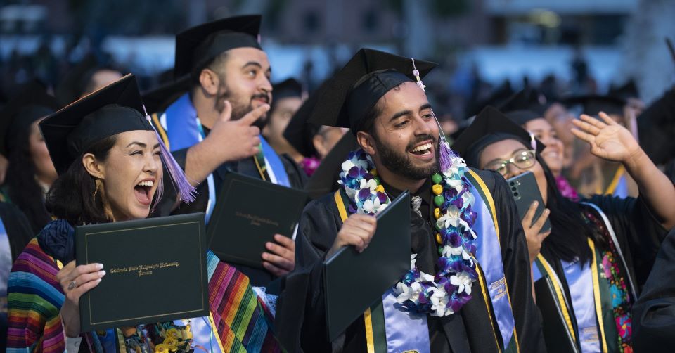 Students at College of Environmental Design Commencement look off camera