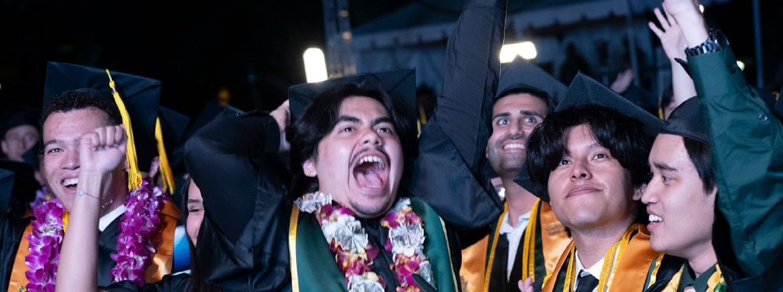 Group of students cheering at Commencement