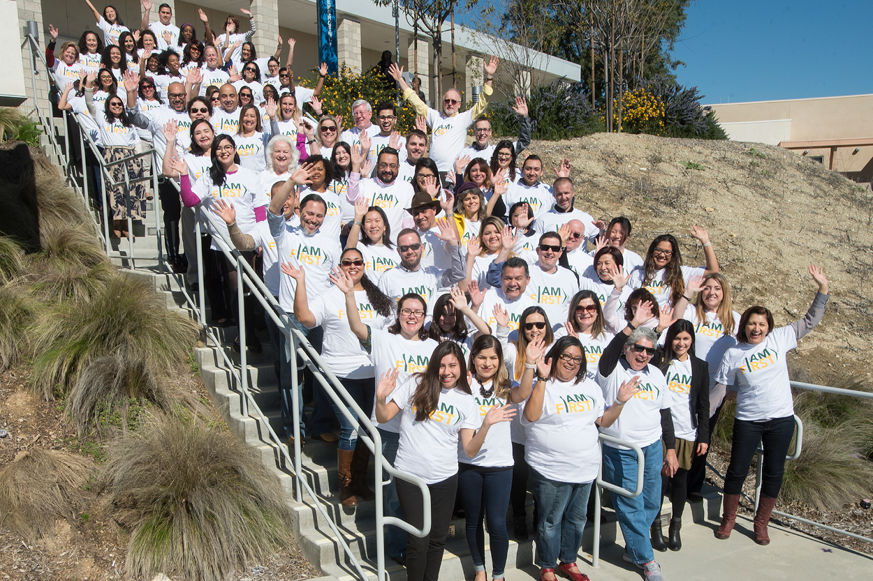 Group of faculty and staff with I Am First shirts on
