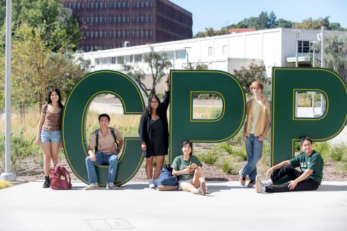 Students posing at letters