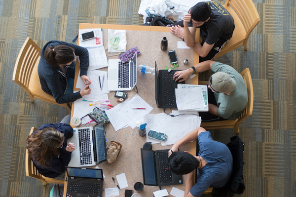 An overhead shot of students studying at a table in the library
