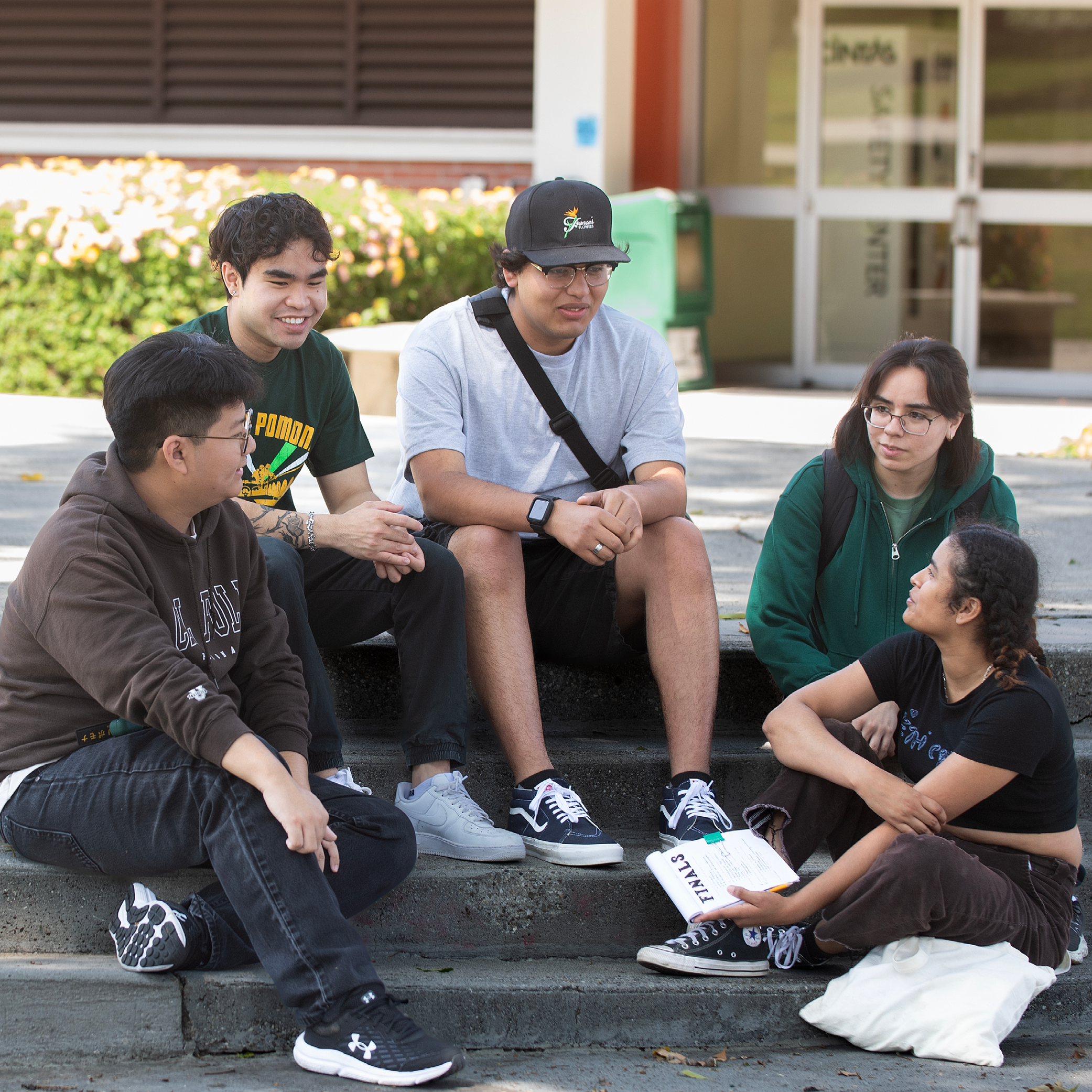 Group of students sit on the steps