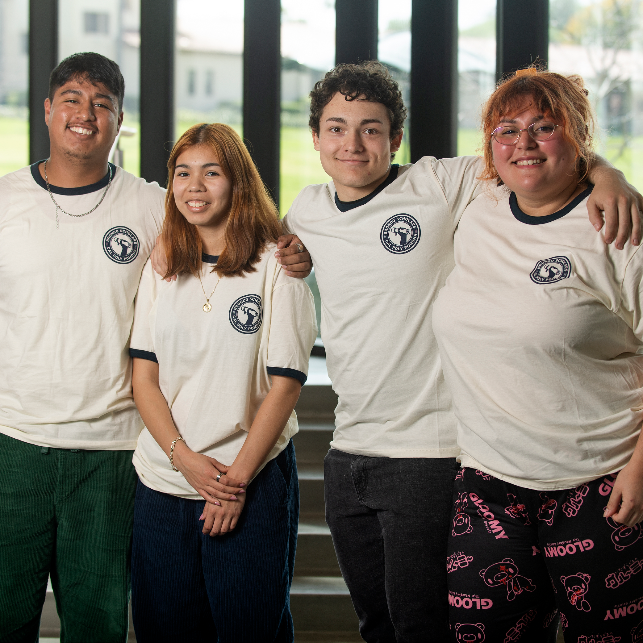 Group of four students wearing Bronco Scholars t-shirts
