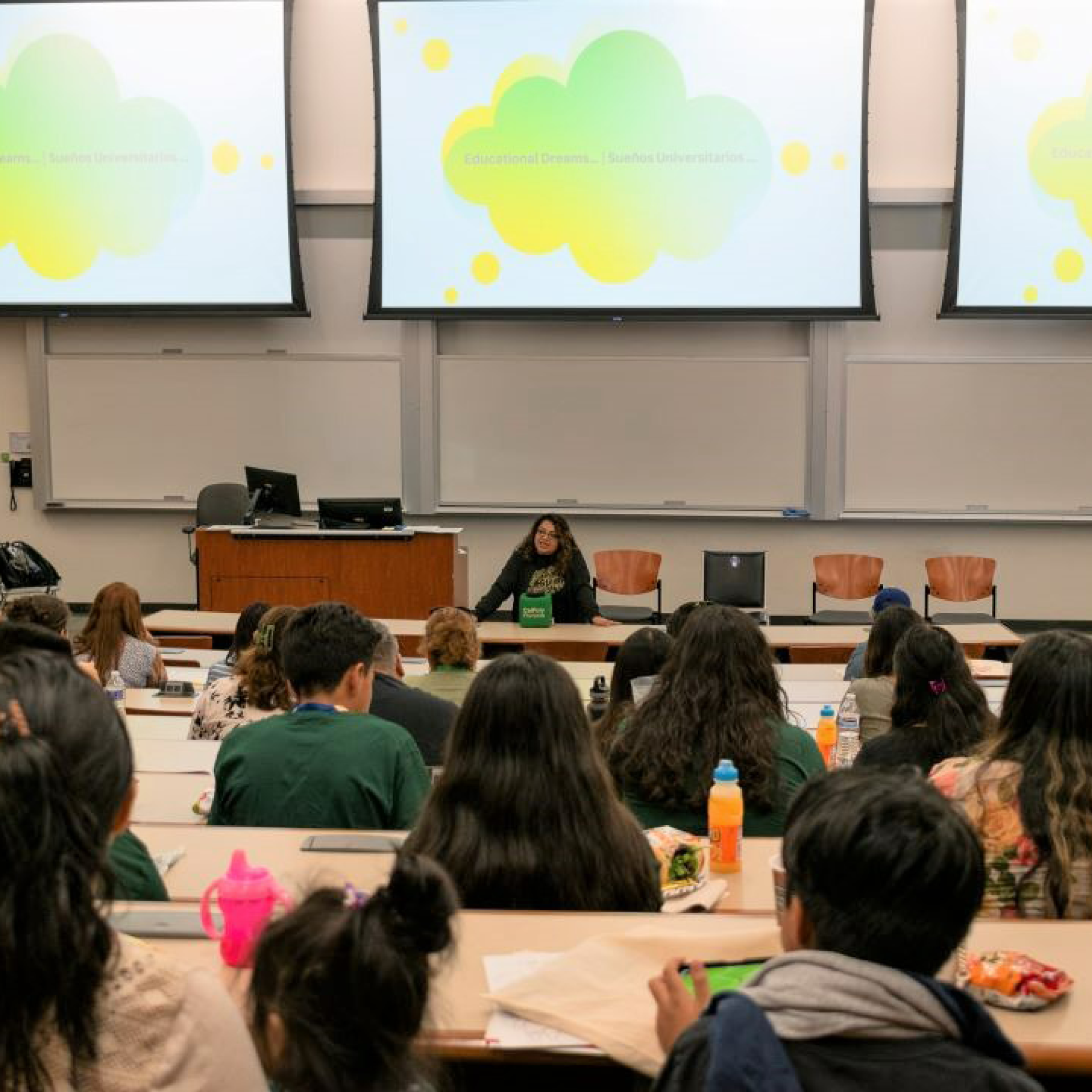Photo of woman giving presentation to lecture hall