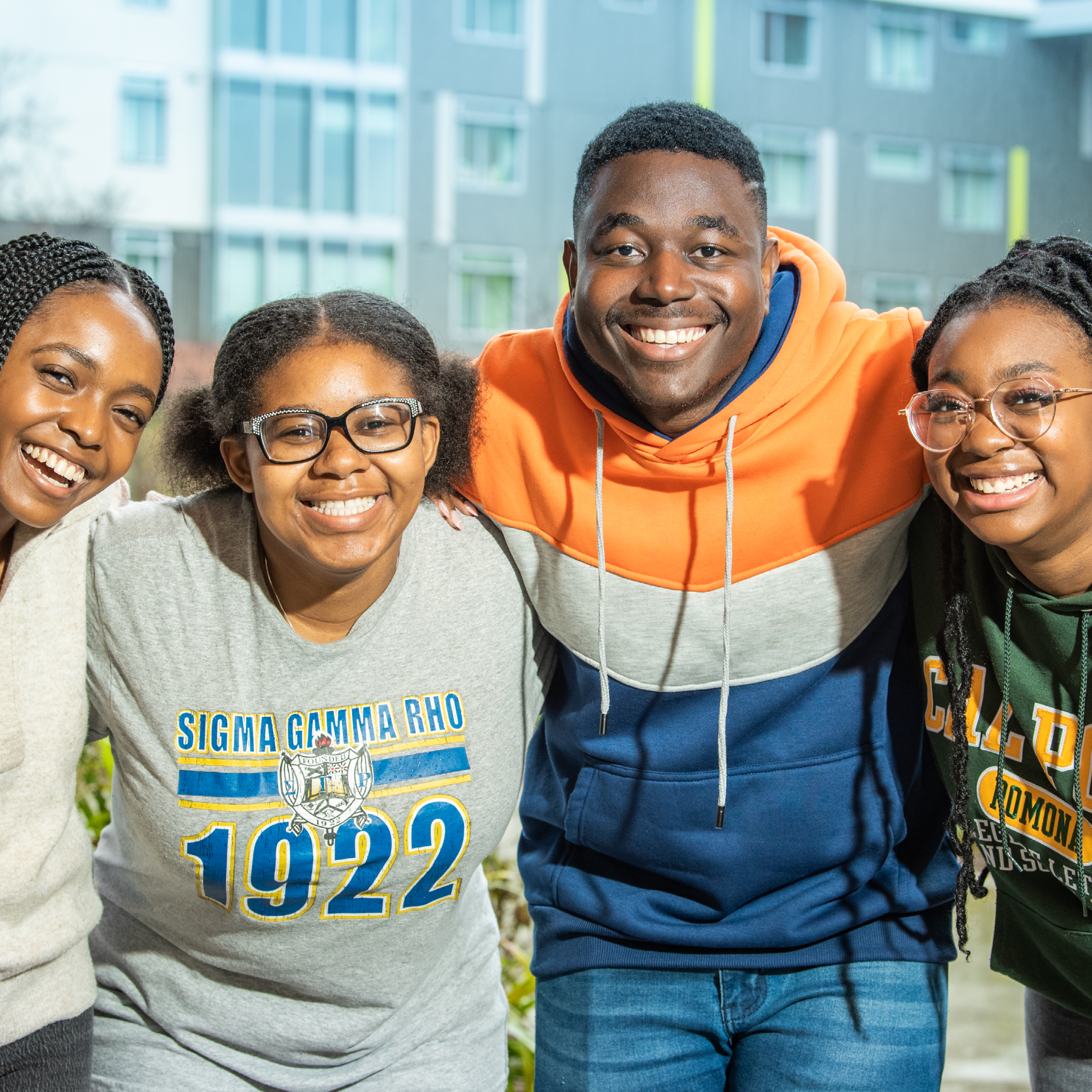 Group of four students posing for camera