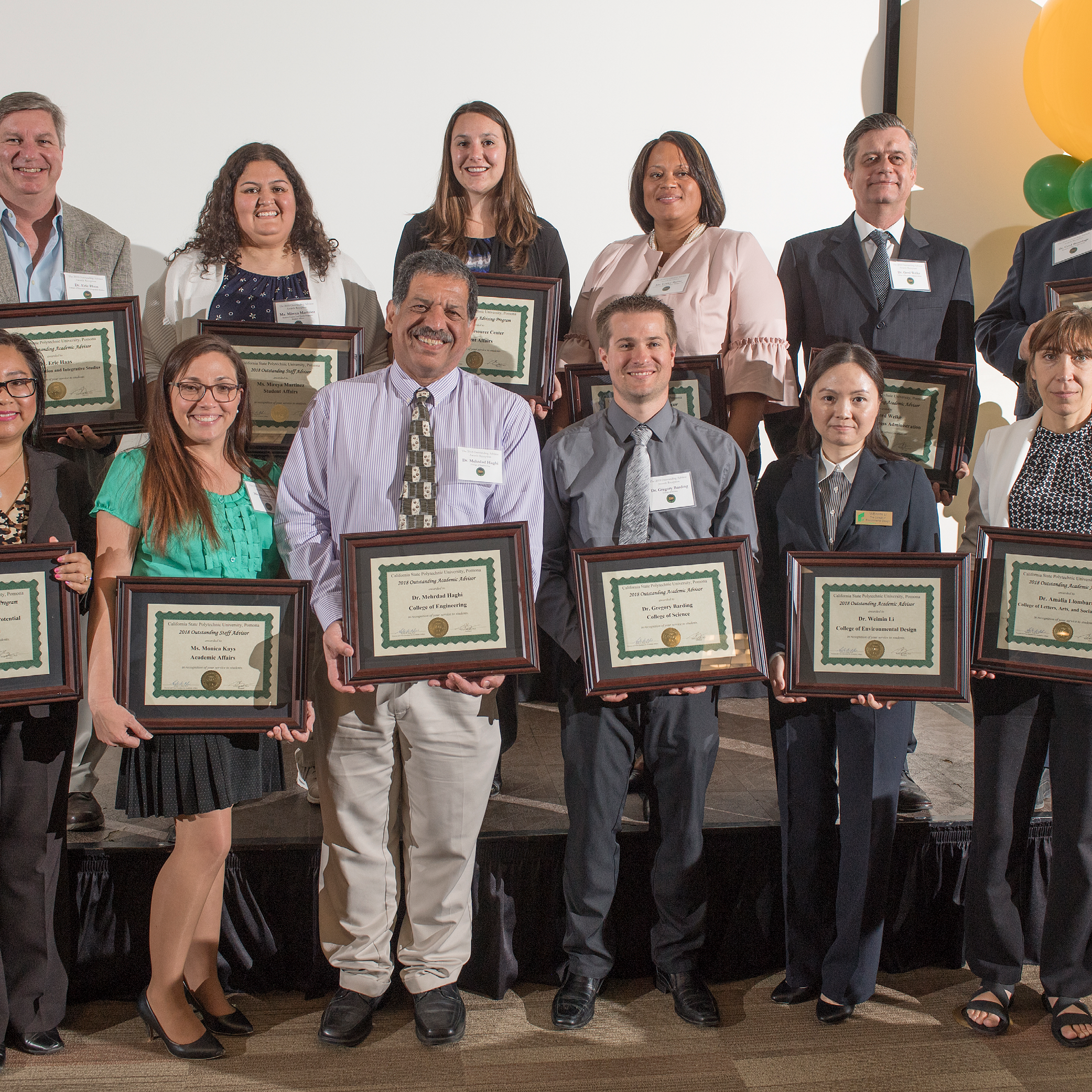 Group of advisors posing with awards at ceremony