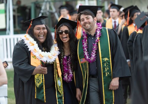 Three students posing at Commencement