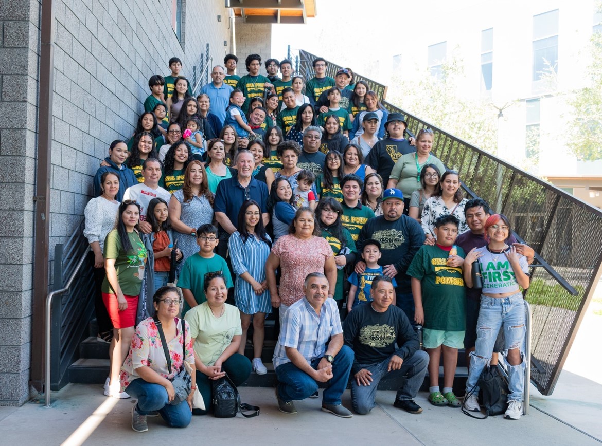 Parents and fanily pose on the steps of the CBA Building.