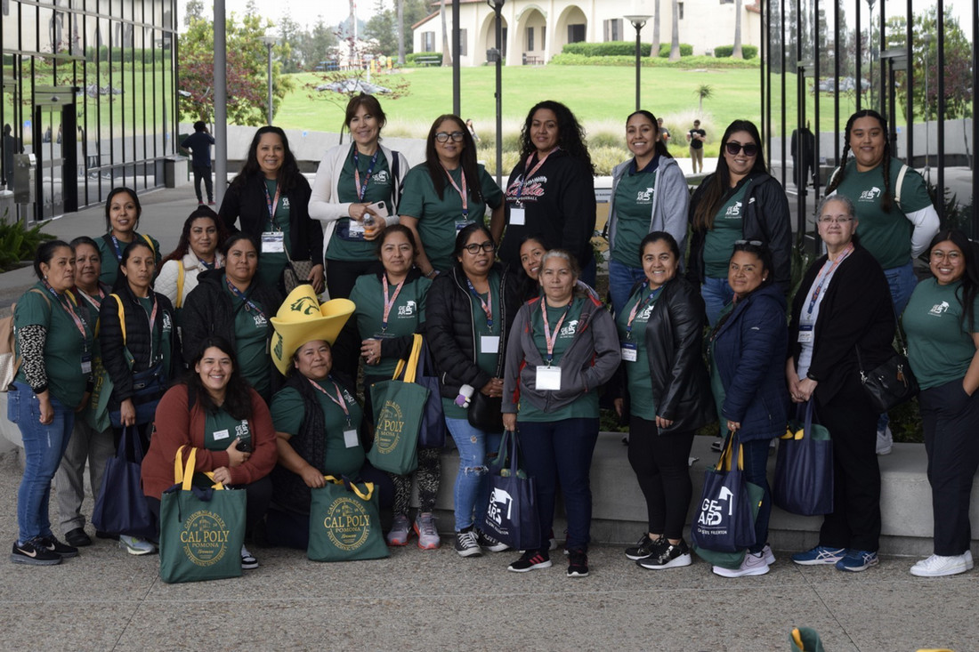 A group poses together in the Student Services Breezeway