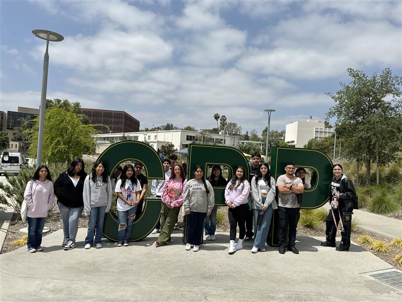 Students pose in front of the CPP letters