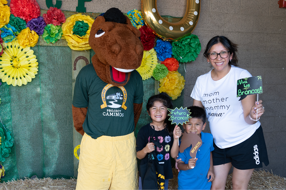 A mom and her two children pose with Billy Btronco
