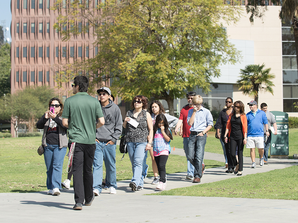 A CPP student leads a group on a campus tour