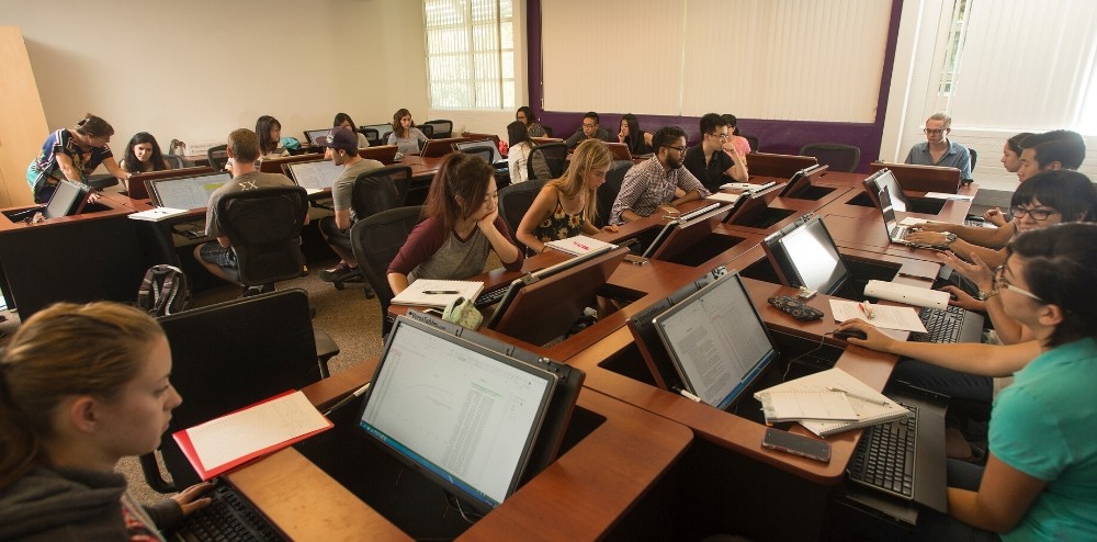 Students use laptop stations during class