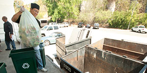 Throwing biodegradable trash bags with food scraps for composting into separate bins for this purpose