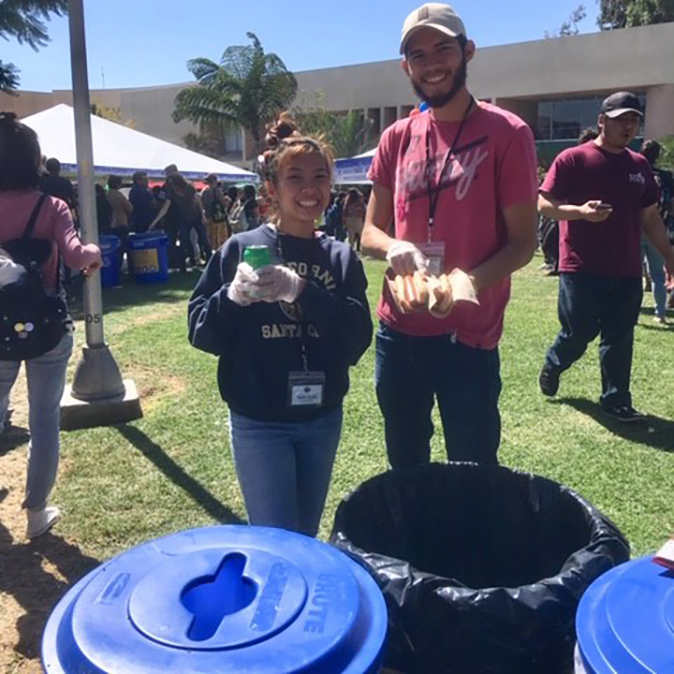 Students assisting to sort recycling at event