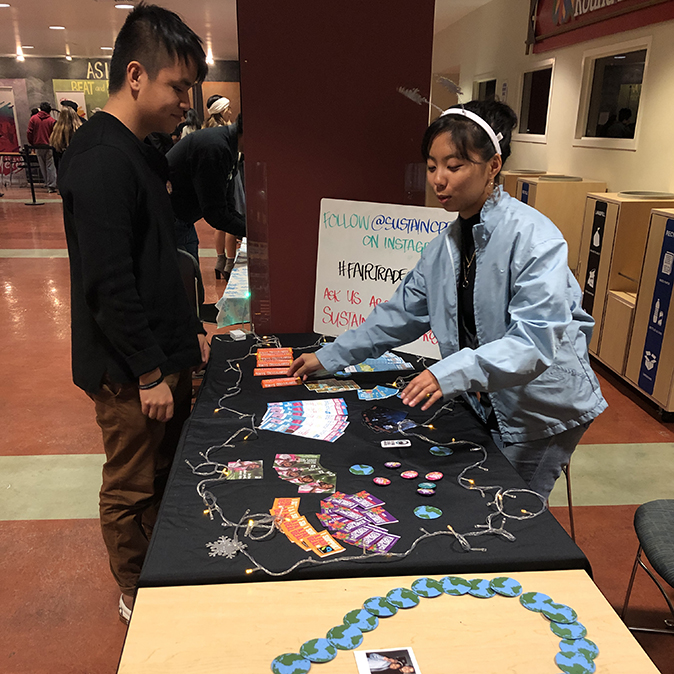 Student at table presenting sustainability information