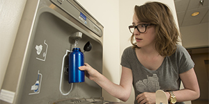 Filling reusable water bottle at a CPP Hydration Station