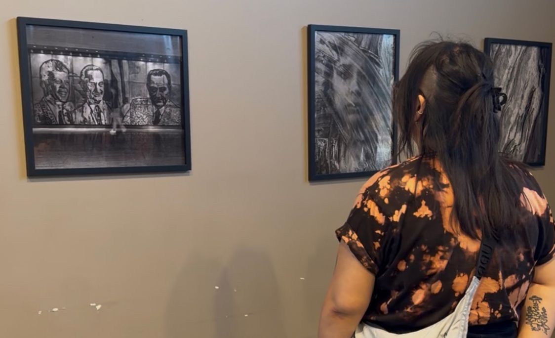student observing art piece