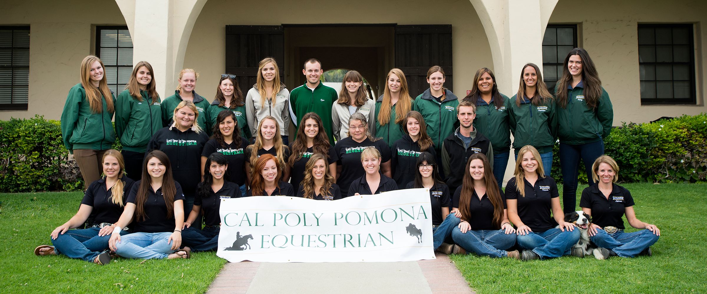 The 2013 equestrian team in front of the old stables on campus. 