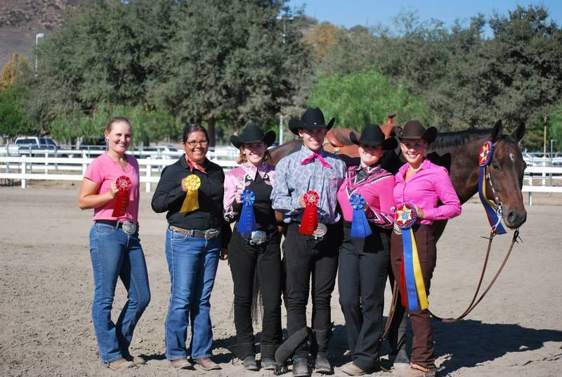 equestrian winners holding their badges