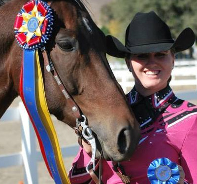 woman next to her horse with winning badges icon