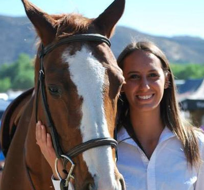 a woman smiles with her horse icon