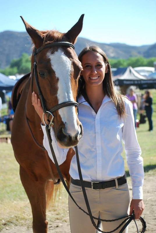 a woman smiles with her horse