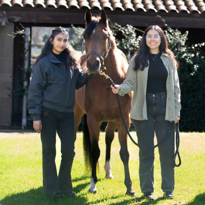 Students standing with horse