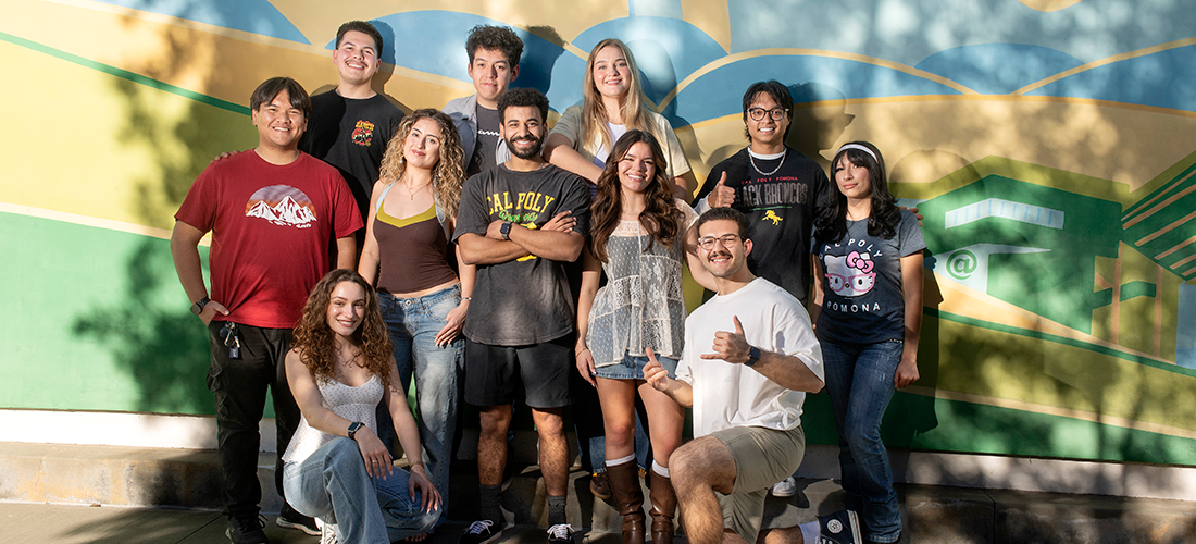 Students pose by the mural at Parking Structure II on campus.