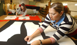 student pinning patterns on fabric