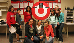 students posing in with a Target logo in the back