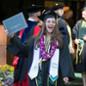 A graduate celebrates after receiving her diploma.