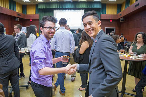 Associated Students Chapter members shaking hands.