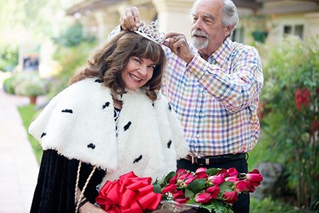 Sandi Davis (’72, office management) and Ron Simons (’64, agronomy; ’69, food, marketing and agribusiness management) re-enact the 1970 Poly Vue Queen crowning at her retirement in 2014.