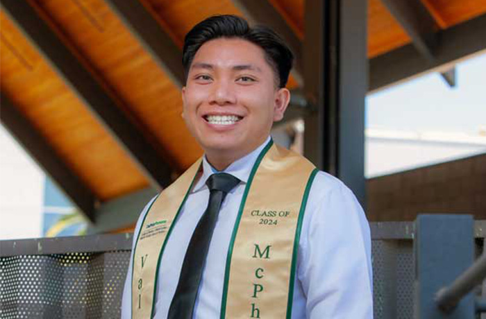 Sean Lee in CBA Courtyard wearing McPhee Scholar stole