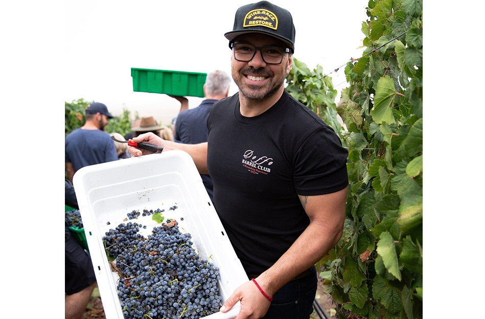 Damian Doffo holding a bucket of grapes