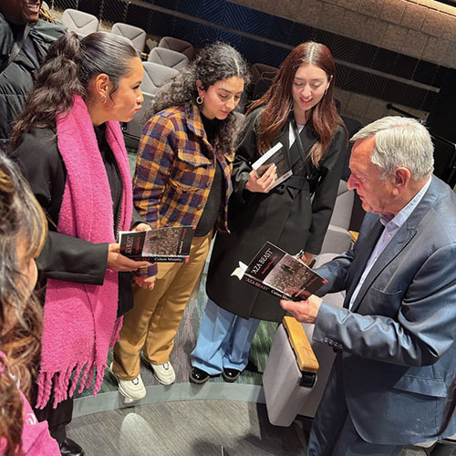 Colum de Sales Murphy, president and founder of the Geneva Graduate School of Diplomacy and International Relations, meets with students and signs copies of his book after his lecture.
