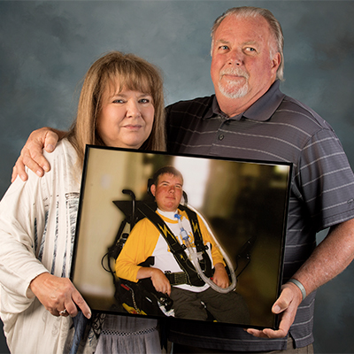 The Strands hold a photo of their son. 