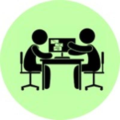 icon of two individuals sitting at desk reviewing documents