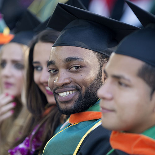 A black, male Cal Poly Pomona engineerng graduate smiling at the camera.