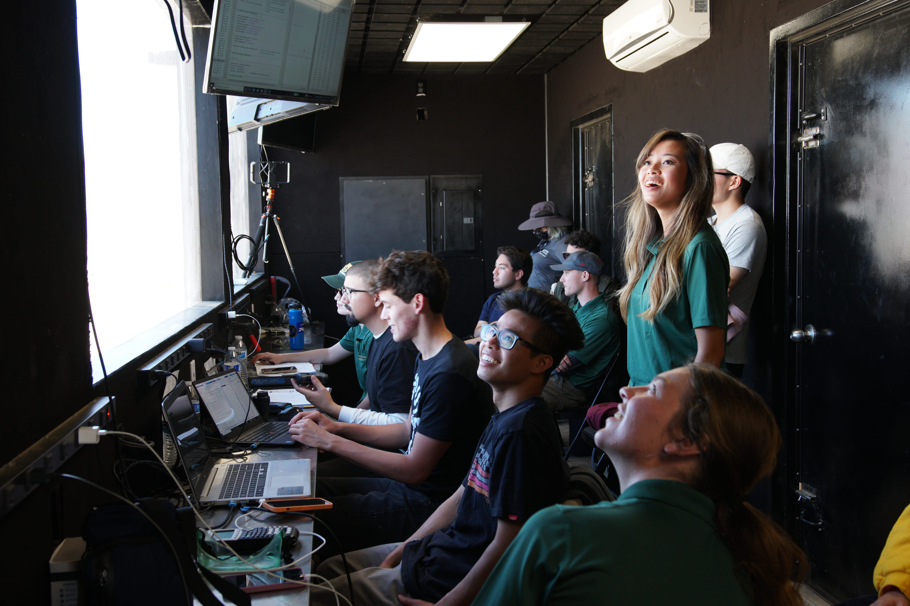 A group of engineernig students in a test launch command bunker.