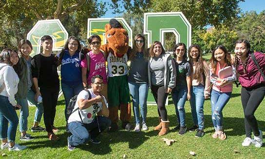 A group of Cal Poly Pomona students with a person in a Billy Bronco costume in the middle.