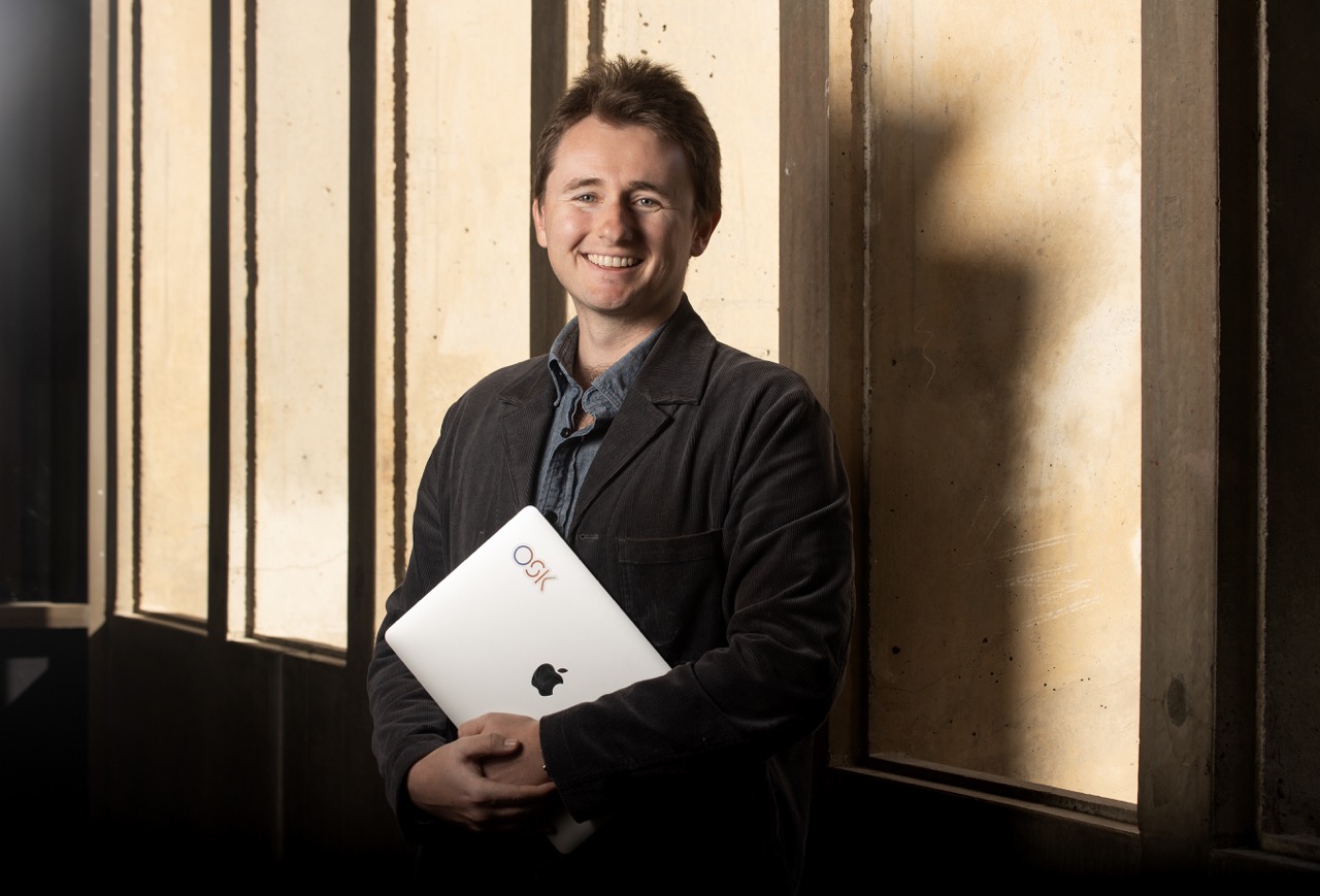 Daniel Aley posing with laptop