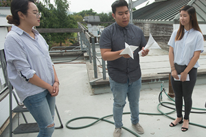 Architecture students examine a prototype component for a green roof system
