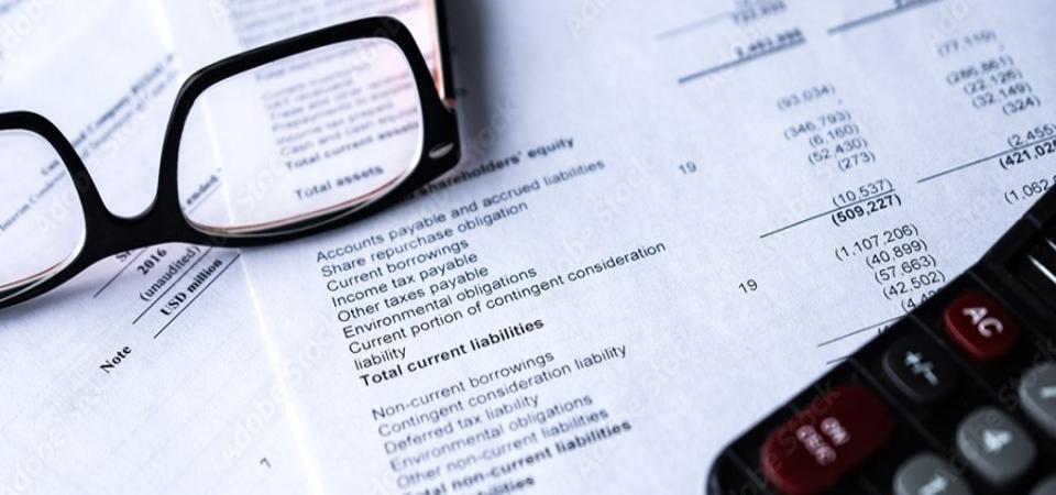 financial document with reading glasses