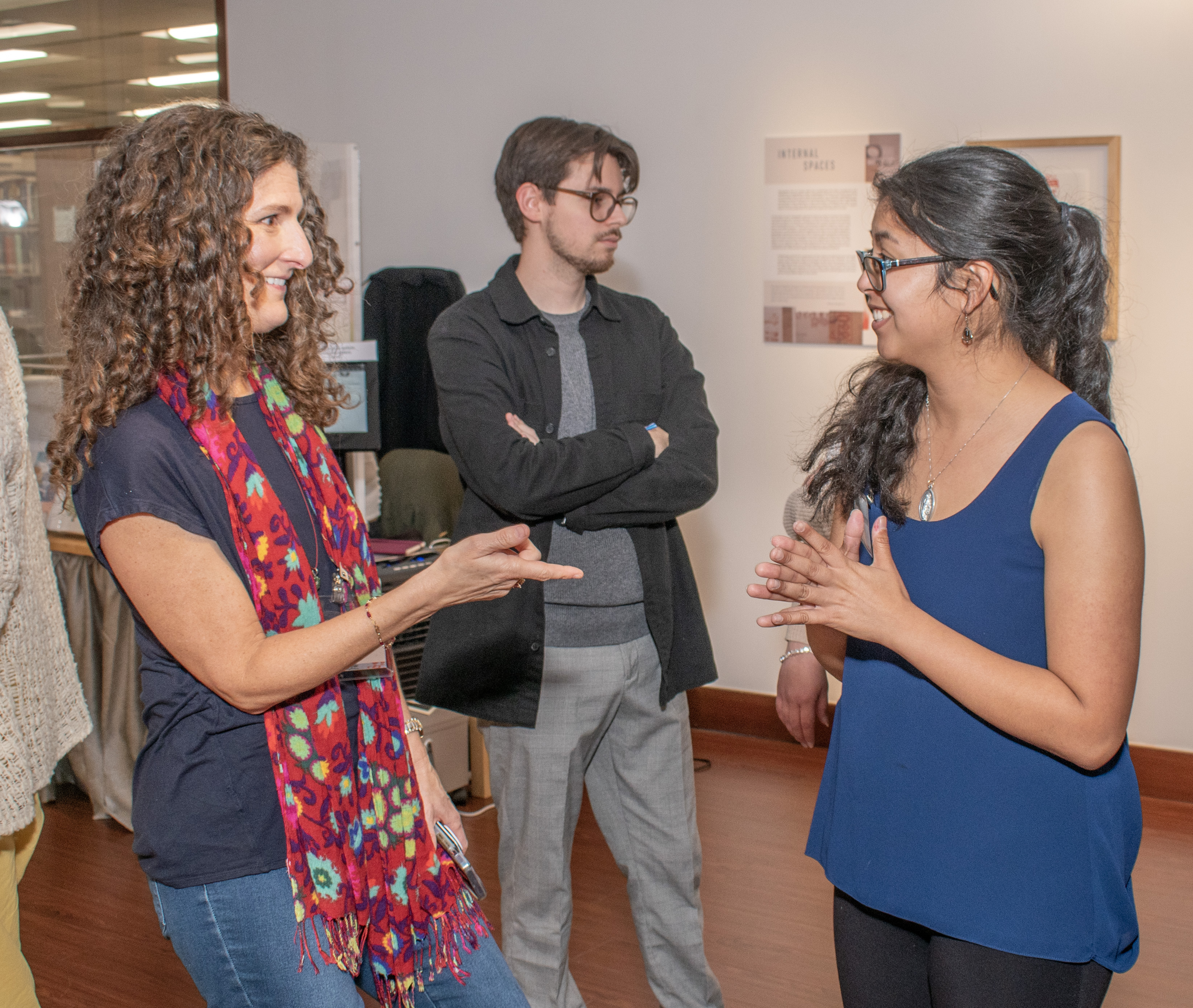 A photograph of Sarah Meyer conversing with one of the gallery staff members about the exhibition.